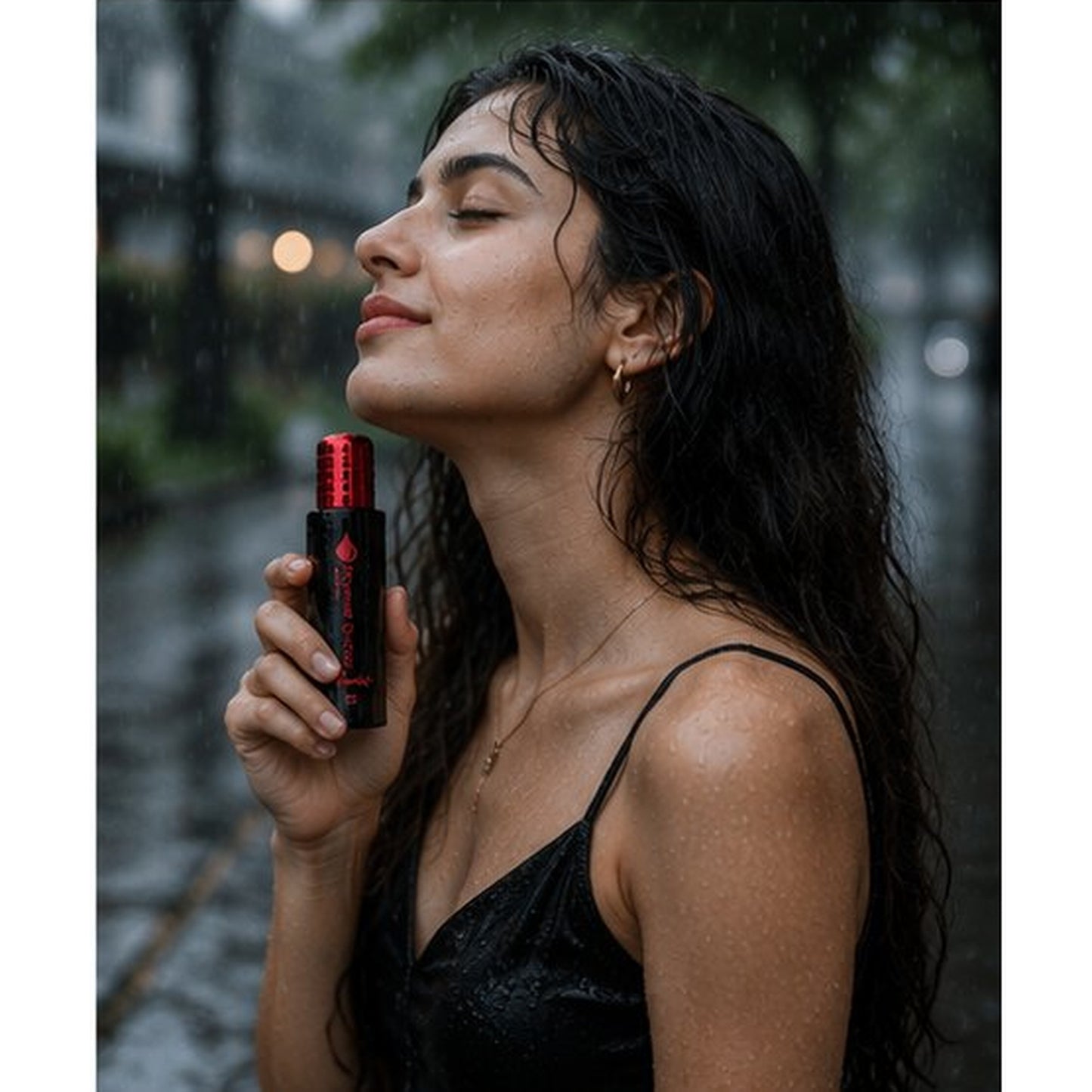 Woman holding a red and black bottle